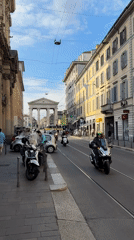 Cyclist performs tricks near advertising trolley in Milan