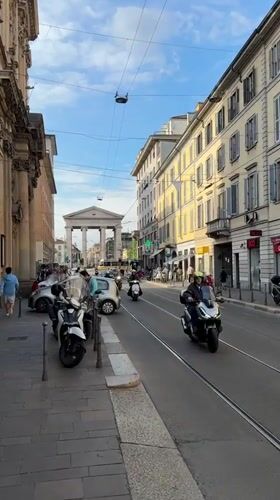 Cyclist performs tricks near advertising trolley in Milan