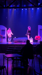 Late-night theatrical performance captured on stage in Buenos Aires