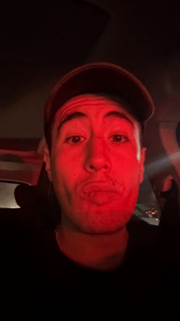 Man photographed in car listening to music in Puebla
