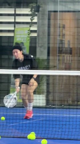 Indoor padel session at a Thai academy, multiple players in action