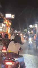 Night ride through Depok's lit-up commercial streets