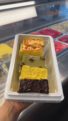 Five colorful layered gelato bars on display in Antalya