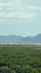Rural Vietnam landscape shows construction activity amid green fields
