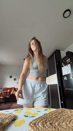 Woman films morning dance session in Belgrade apartment