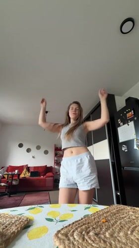 Woman films morning dance session in Belgrade apartment