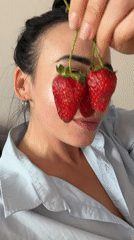 Woman poses with strawberries, artist paints goldfish in Russia