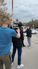 Young men gather on Varna sidewalk during overcast day