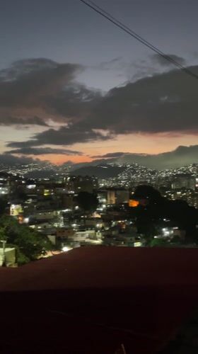 Nighttime scenes in Caracas feature cityscape view and cat