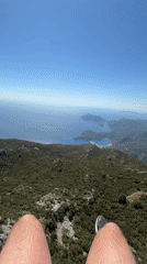 Paragliders launch and fly over Fethiye coastline