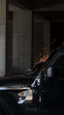 Black Jeep Wrangler parked on a Tbilisi street