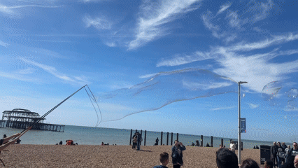 Man creates giant soap bubbles on Brighton beach