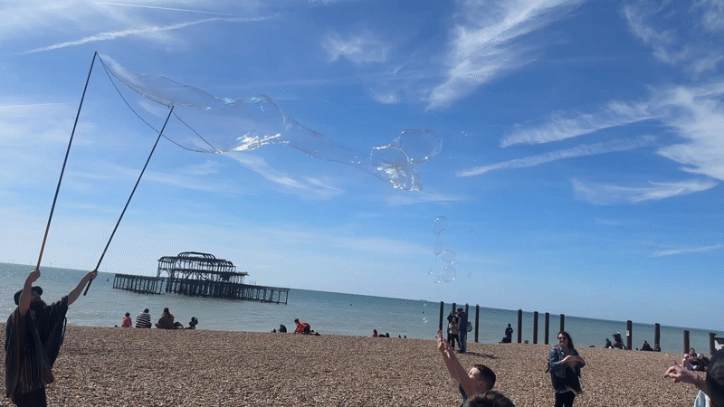 Man creates giant soap bubbles on Brighton beach