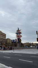 Abstract polka-dotted sculpture draws pedestrians in Barcelona street scene