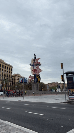Abstract polka-dotted sculpture draws pedestrians in Barcelona street scene