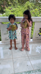 Children enjoy fresh coconuts in Kiblawan, Philippines morning scenes