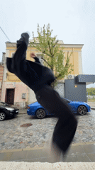 Man in black performs activity on wet Shumen street