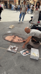 Street artist draws chalk portraits in Florence public square