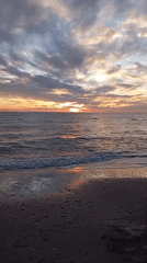 Sunset over a calm Baltic beach in Šķēde, Latvia