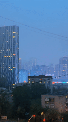 Foggy night captured in Yekaterinburg featuring distinctive skyscraper
