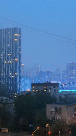 Foggy night captured in Yekaterinburg featuring distinctive skyscraper