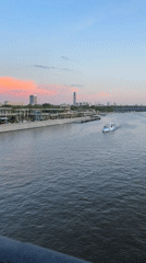 Passenger boat travels Moscow river during sunset evening