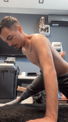Man exercises indoors, pets dog during workout in Sofia