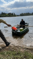Father and child enjoy afternoon boat ride on Latvian lake
