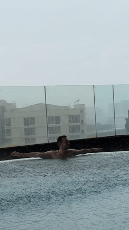 Rainy rooftop pool day and gym session in suburban Bangkok