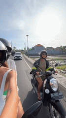 Women ride motorcycles through North Kuta streets after midnight