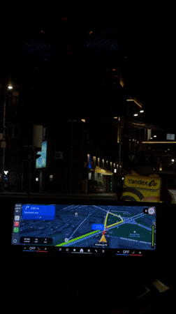 Woman drives through Yerevan at night with GPS navigation