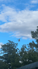 Red helicopter hovers over Plovdiv during afternoon car wash