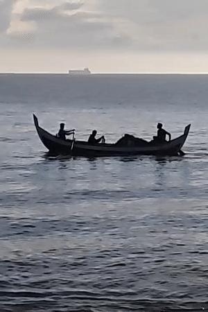 Sunrise on the Lhokseumawe coast, fishing boat and quiet shoreline