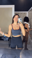 Woman takes mirror selfies in gym locker room