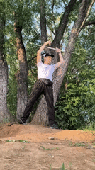Stick juggling on a dirt mound in Karaganda, Kazakhstan