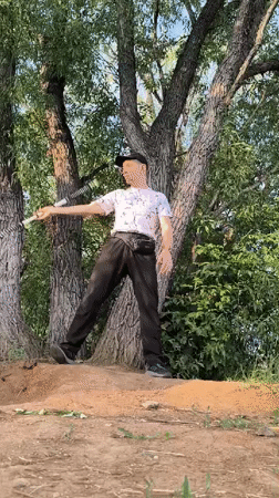 Stick juggling on a dirt mound in Karaganda, Kazakhstan