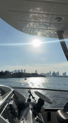 Boater films Miami skyline sunset from yacht cockpit