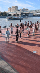 Group dance on a waterside wooden platform in Moscow
