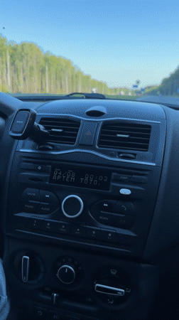 Driver adjusts radio while traveling highway near Pugachevo