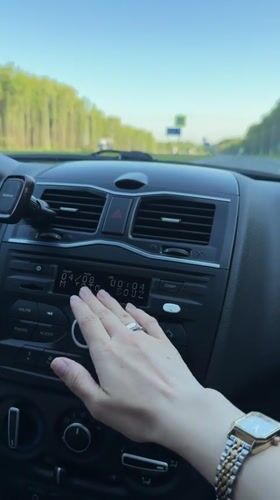 Driver adjusts radio while traveling highway near Pugachevo