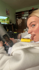 Woman takes playful selfies on couch in Murino