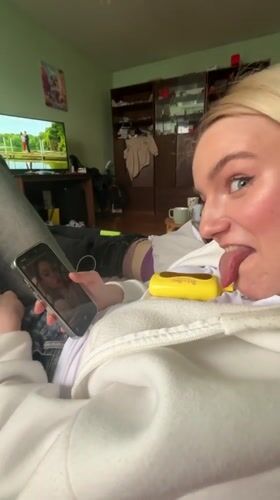 Woman takes playful selfies on couch in Murino