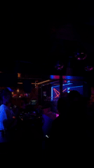 Late-night club scene with DJ setup in Wrocław