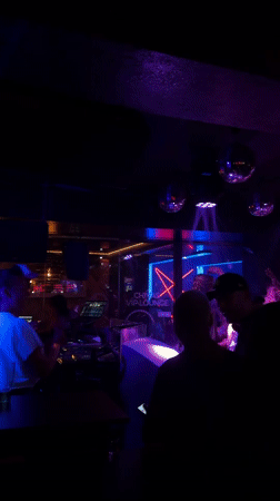 Late-night club scene with DJ setup in Wrocław