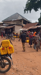 Villagers queue with jerry cans for water collection