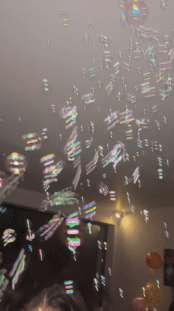 Person catches bubbles in balloon-filled room in Bulgaria