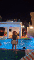 Night swimming captured at illuminated pool in Ban Bang Rak