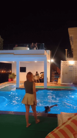 Night swimming captured at illuminated pool in Ban Bang Rak