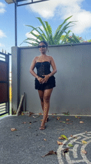Woman films dance video in Sukawati driveway