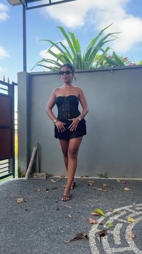 Woman films dance video in Sukawati driveway